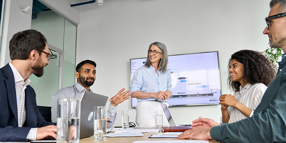 Diverse executive team people discussing company strategy at board meeting. Strategic Planning
